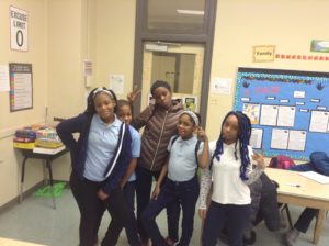Five Chicago school students posing in a classroom.